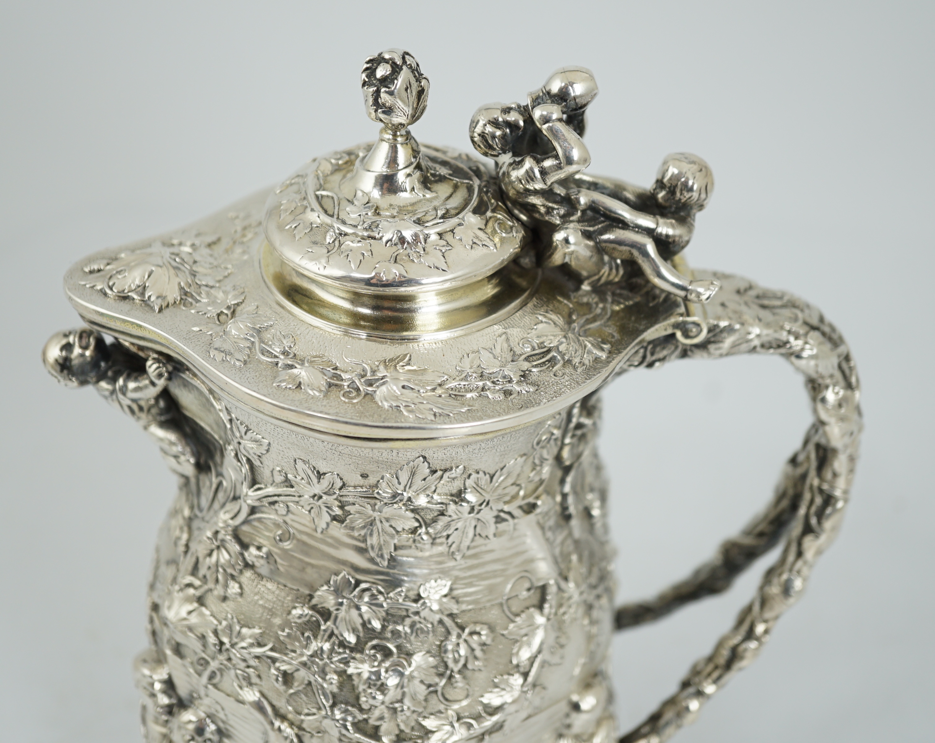 ROYAL INTEREST: A good ornate Victorian Teniers style silver ewer with hinged cover by Frederick Elkington